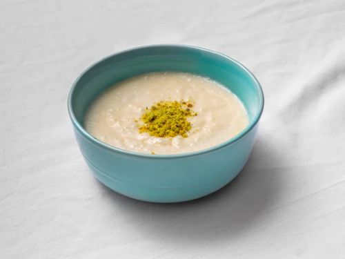 Sweet gulab jamun, creamy ras malai, kheer, and halwa served in traditional bowls with vibrant garnishes.